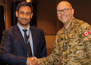 An industry delegate and a Canadian Armed Forces officer shaking hands at Best Defence