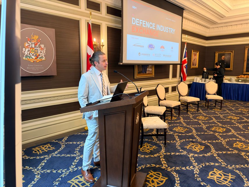 Speaker at the podium opening the Defence Industry Exchange